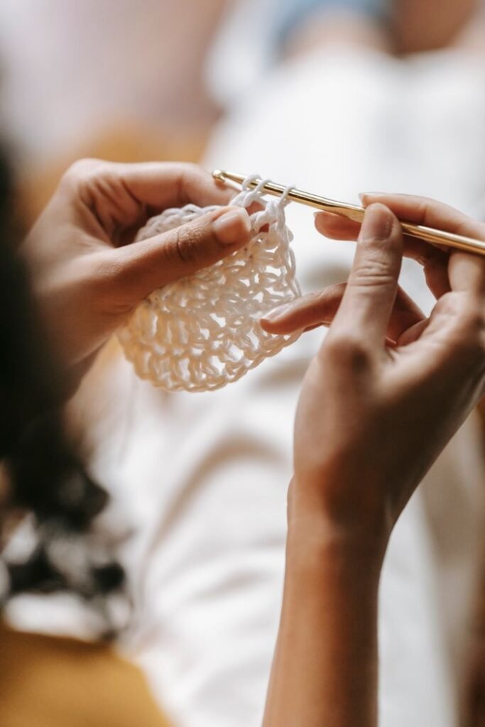 Mastering the First Impression: Your intriguing post title goes here Intimate close-up of woman's hands knitting with white yarn, capturing the art of handmade craftsmanship.